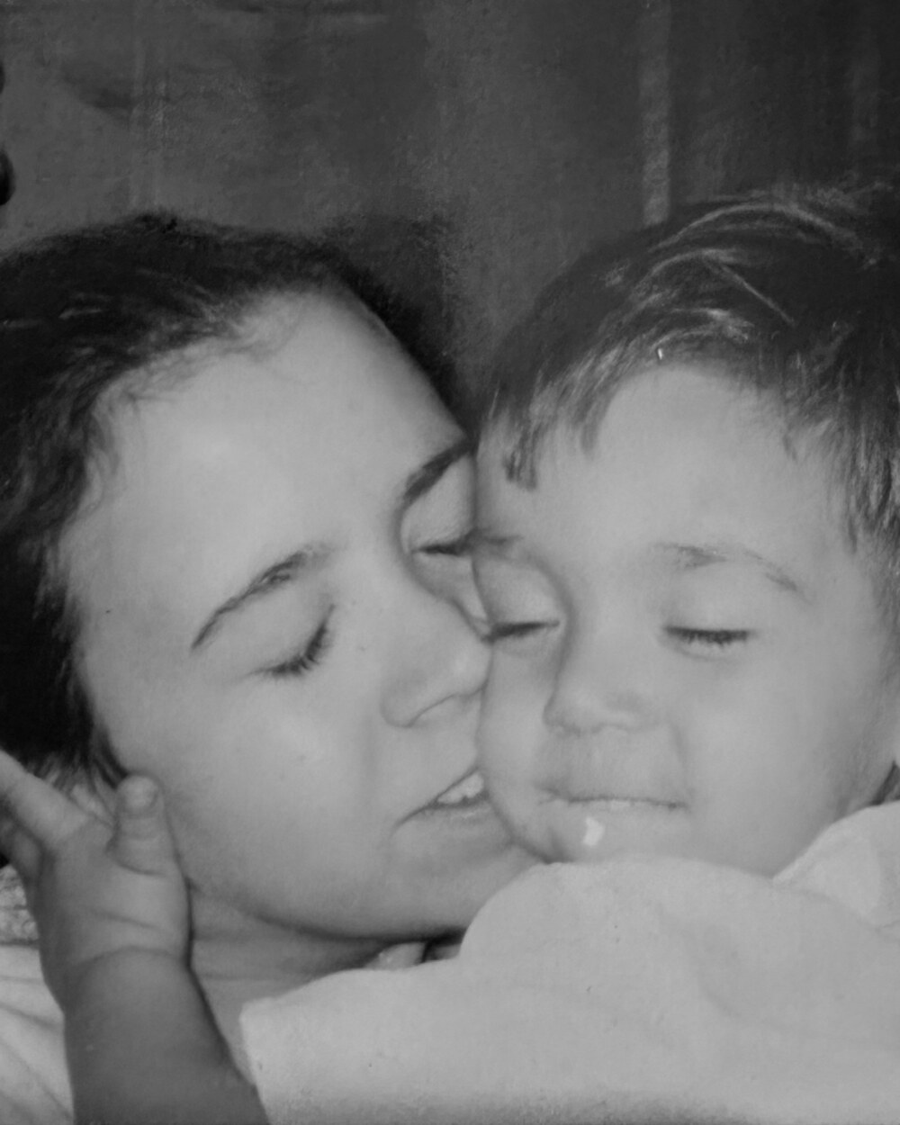 Rachel kissing Tristin on the cheek when he was a child