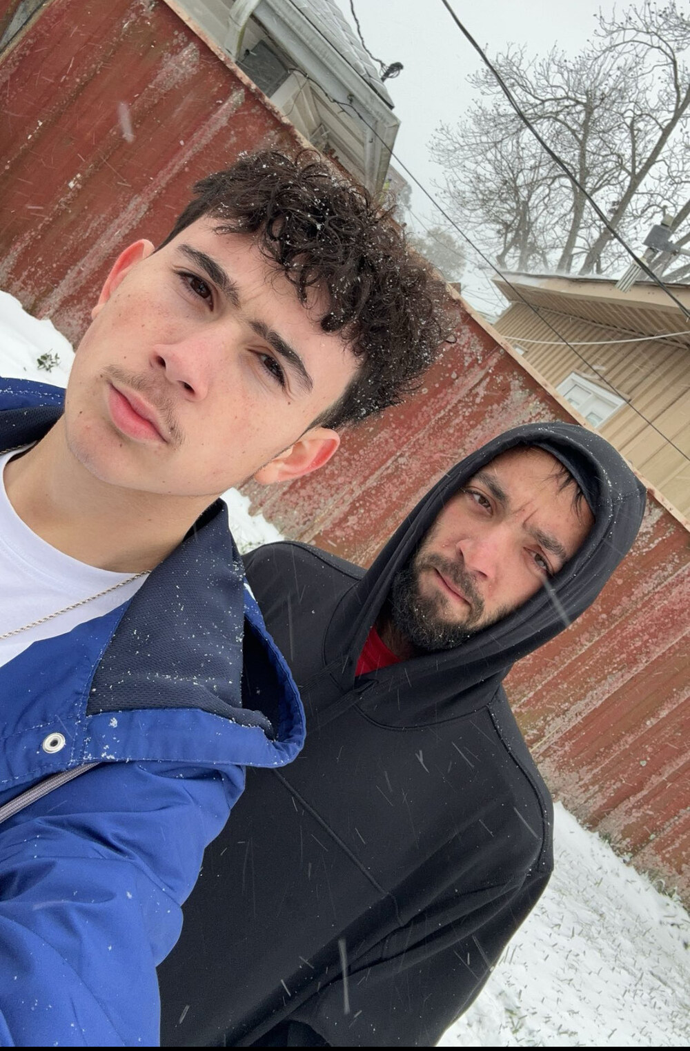 Tristin standing in the snow with his younger brother
